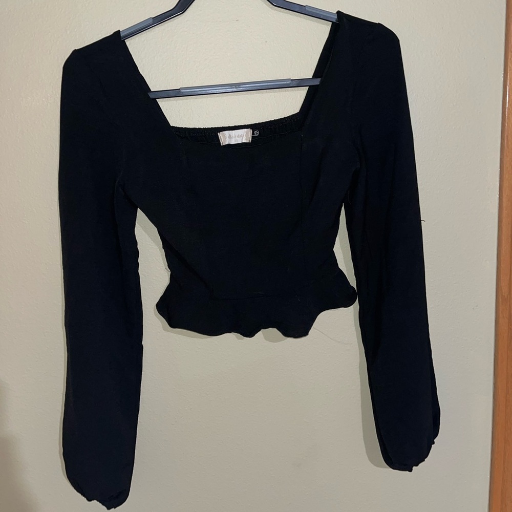 Black cuffed long sleeve with fitted bust and flared bottom